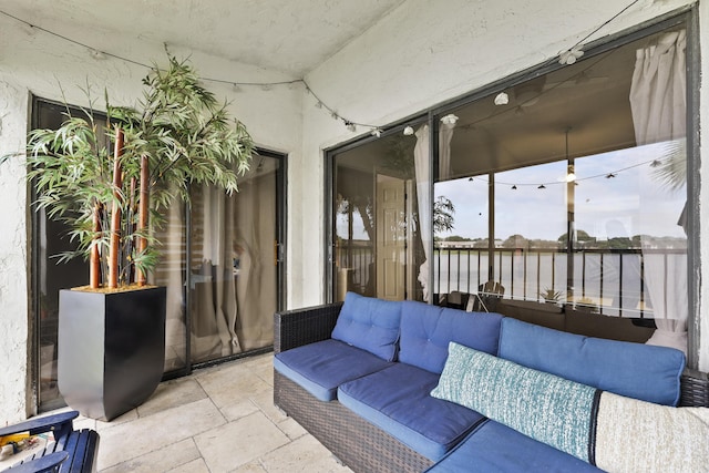 sunroom / solarium featuring a water view