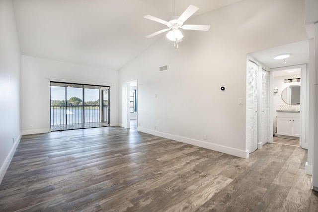 empty room featuring ceiling fan, wood-type flooring, and high vaulted ceiling