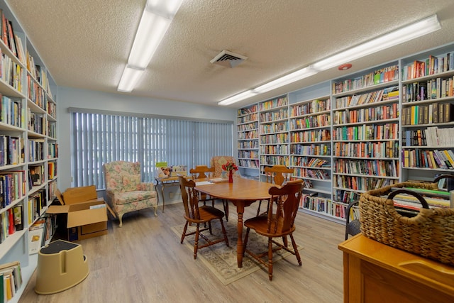 interior space featuring a textured ceiling and light hardwood / wood-style floors