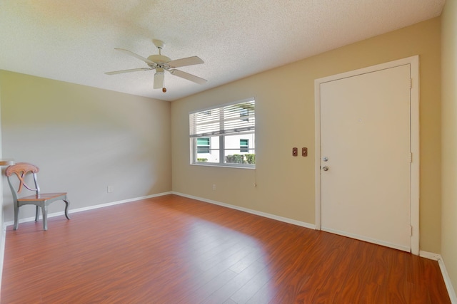 unfurnished room featuring a textured ceiling, wood-type flooring, and ceiling fan