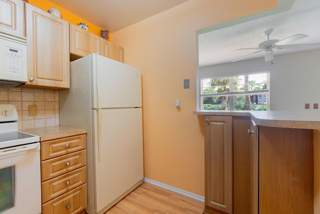 kitchen with a textured ceiling, ceiling fan, backsplash, light wood-type flooring, and white appliances