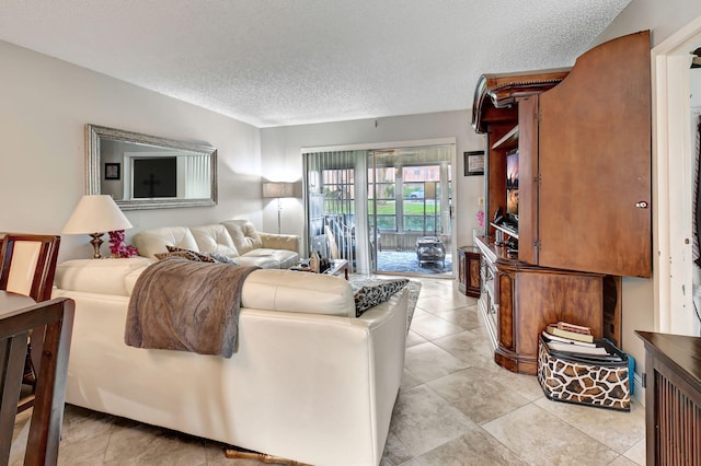 tiled living room featuring a textured ceiling