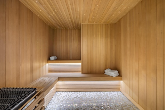 view of sauna featuring wooden walls and wooden ceiling