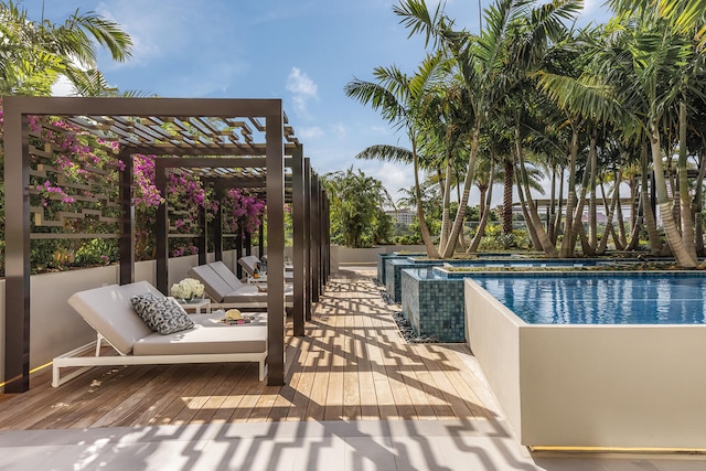 view of swimming pool with a pergola and a deck