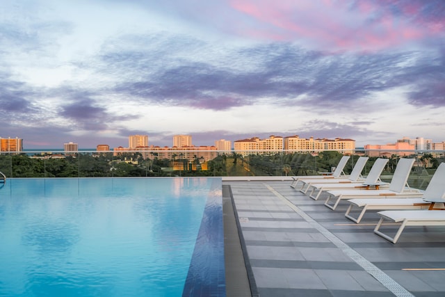 view of pool at dusk