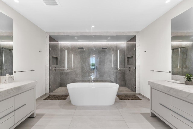 bathroom with tile patterned floors, vanity, and shower with separate bathtub