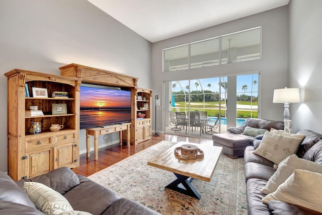 living room featuring hardwood / wood-style floors and high vaulted ceiling