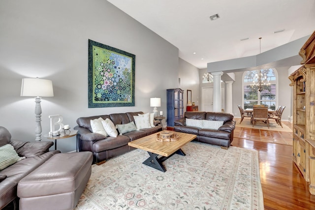 living room featuring decorative columns and light hardwood / wood-style floors