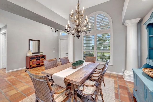 tiled dining area with a chandelier, decorative columns, and plenty of natural light