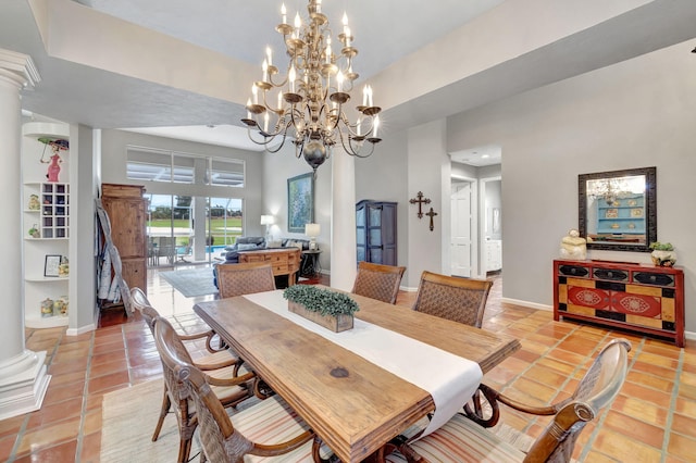 tiled dining room featuring ornate columns and a notable chandelier