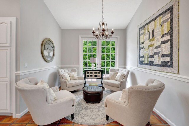 tiled living room featuring french doors, vaulted ceiling, and an inviting chandelier