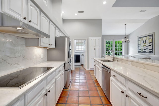 kitchen featuring tasteful backsplash, stainless steel appliances, white cabinets, a chandelier, and hanging light fixtures