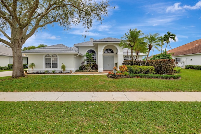 mediterranean / spanish-style house featuring a front lawn