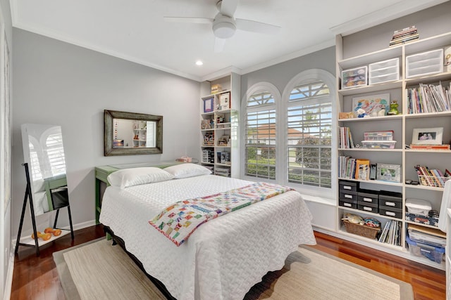 bedroom with ceiling fan, dark hardwood / wood-style floors, and ornamental molding