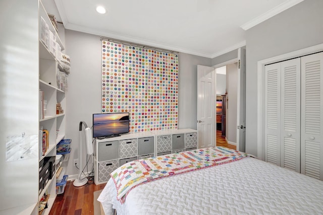 bedroom with hardwood / wood-style floors, a closet, and crown molding