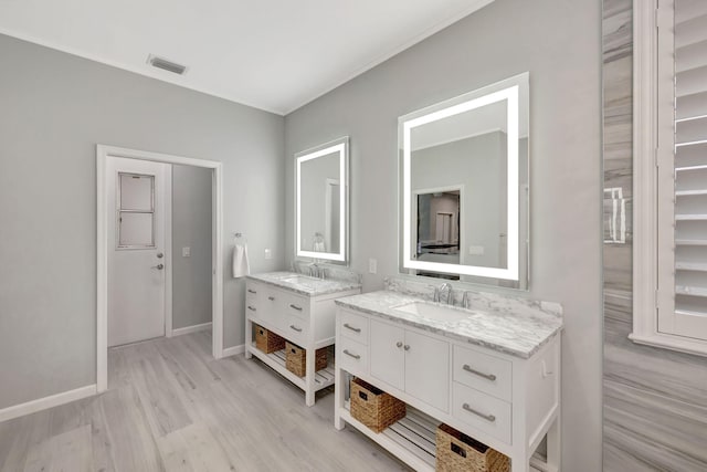 bathroom with hardwood / wood-style floors and vanity