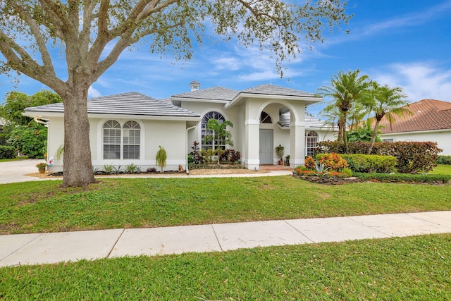 mediterranean / spanish house with a front yard