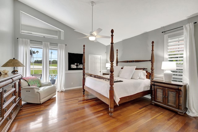 bedroom featuring ceiling fan, hardwood / wood-style floors, and lofted ceiling