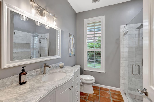 bathroom with tile patterned floors, vanity, toilet, and a shower with door