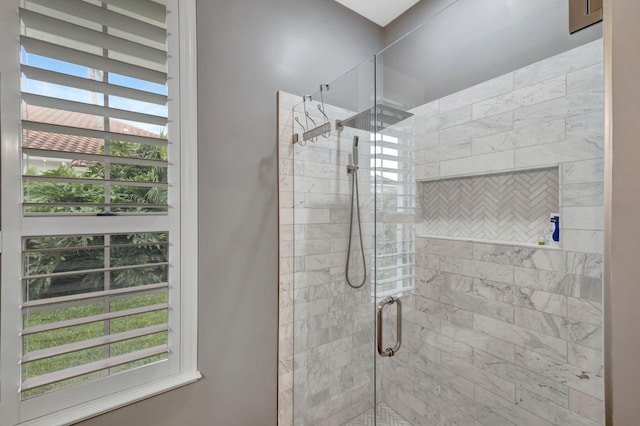 bathroom with plenty of natural light and a shower with door