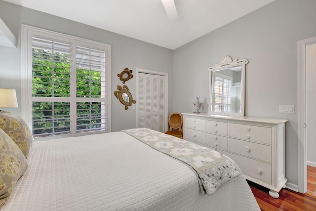 bedroom with a closet, hardwood / wood-style flooring, and ceiling fan