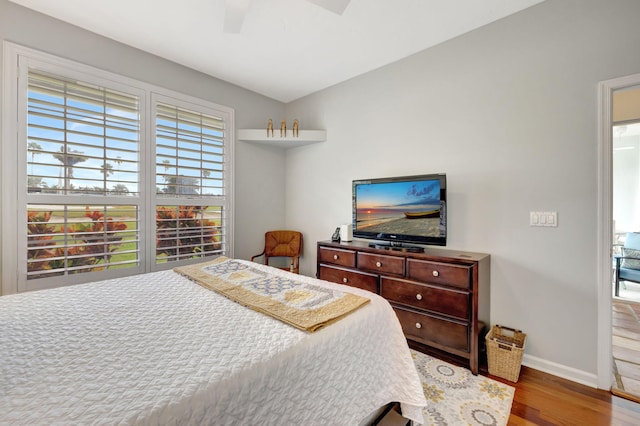 bedroom featuring wood-type flooring, ceiling fan, and lofted ceiling