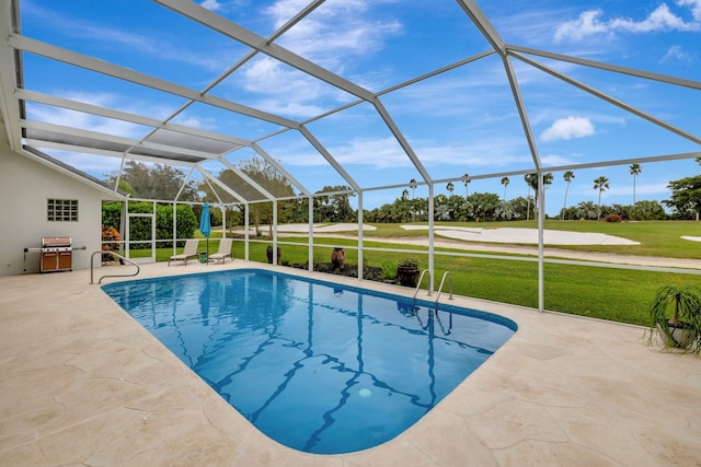 view of swimming pool featuring a lawn, glass enclosure, and a patio area