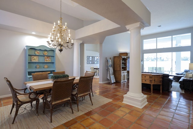 tiled dining room featuring decorative columns and an inviting chandelier