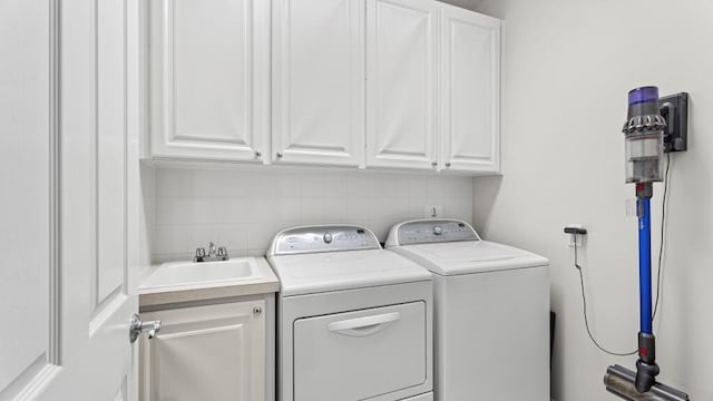 laundry area with cabinets, sink, and independent washer and dryer