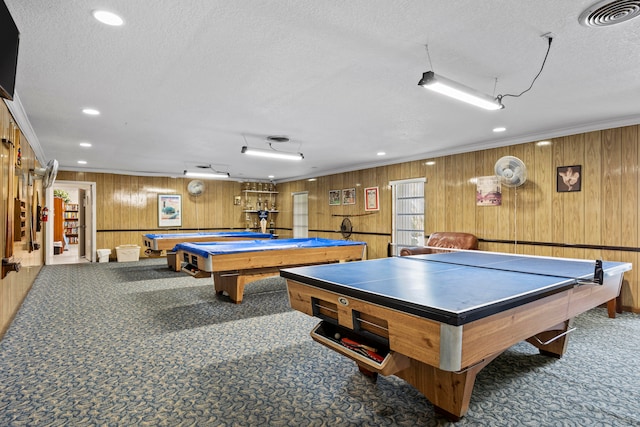 rec room featuring ornamental molding, carpet, and wooden walls