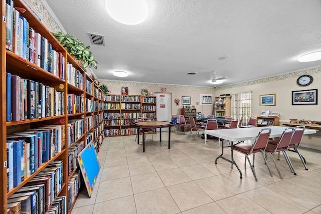 dining space with a textured ceiling and light tile patterned floors