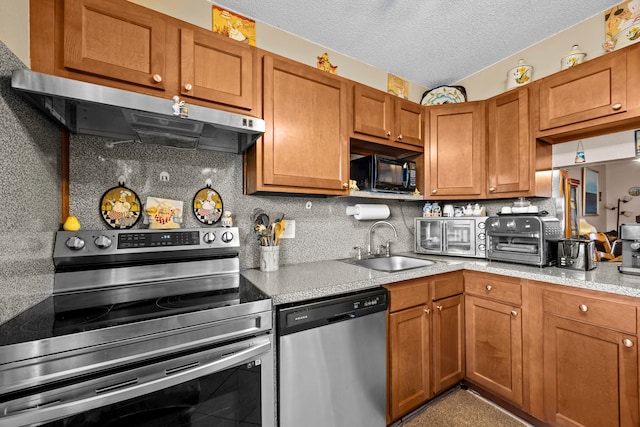 kitchen featuring tasteful backsplash, stainless steel appliances, a textured ceiling, exhaust hood, and sink