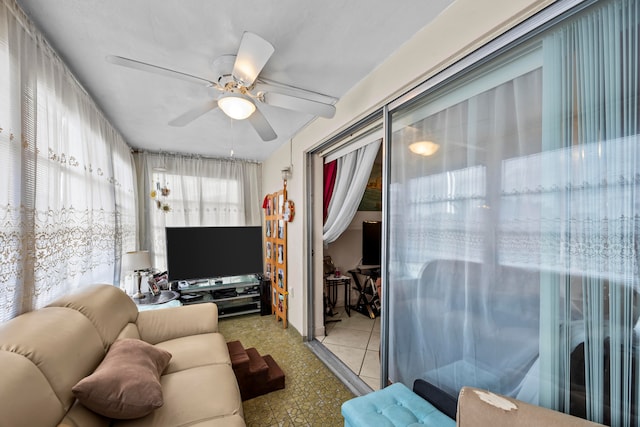 living room with ceiling fan and plenty of natural light