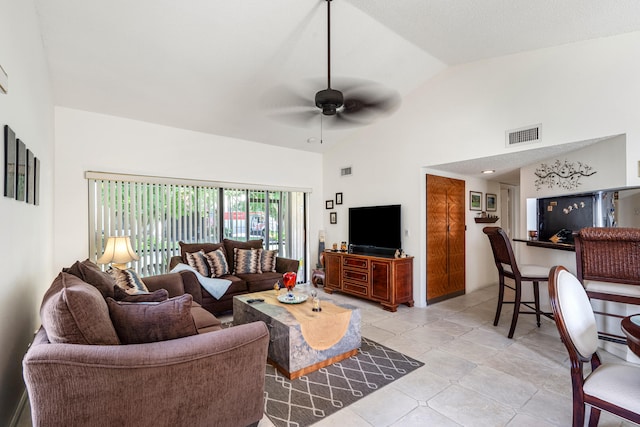 tiled living room with high vaulted ceiling and ceiling fan