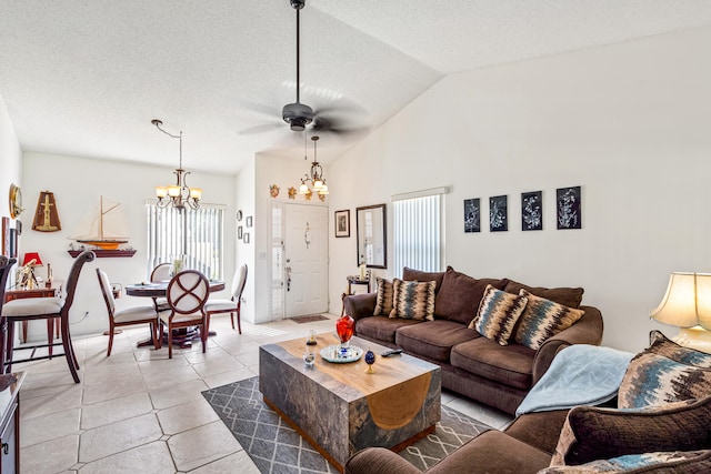 living room with ceiling fan with notable chandelier, a textured ceiling, light tile patterned floors, and lofted ceiling