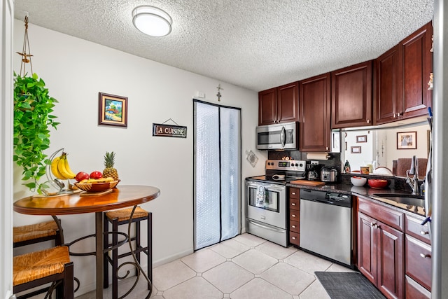 kitchen featuring sink, appliances with stainless steel finishes, and a textured ceiling