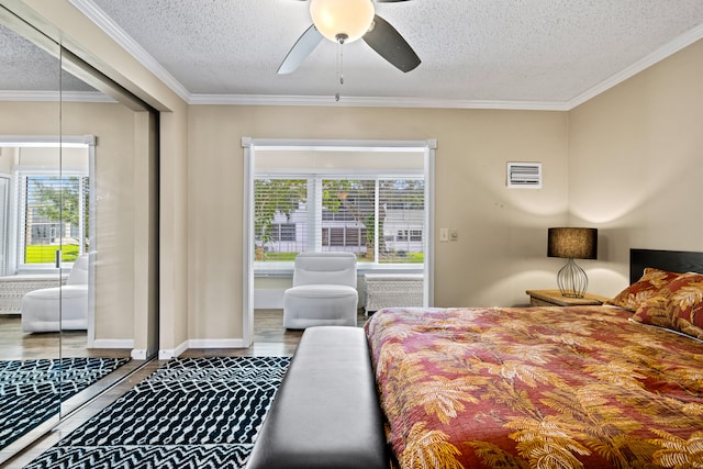 bedroom featuring ceiling fan, multiple windows, a textured ceiling, and crown molding