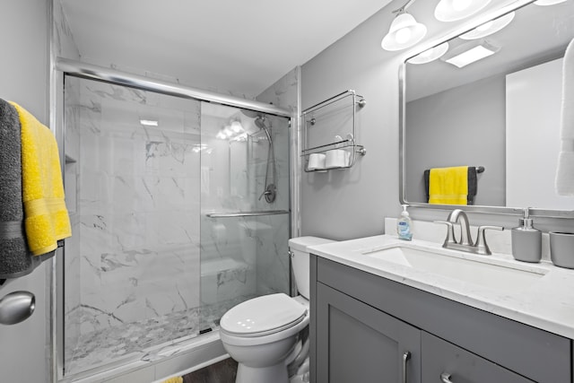 bathroom with hardwood / wood-style flooring, a shower with shower door, vanity, and toilet