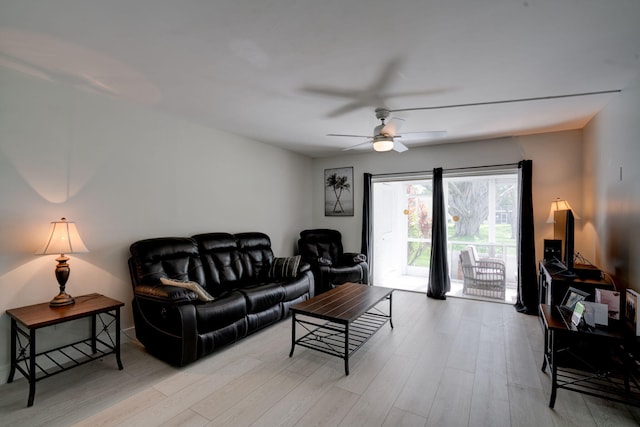 living room featuring ceiling fan and light hardwood / wood-style floors