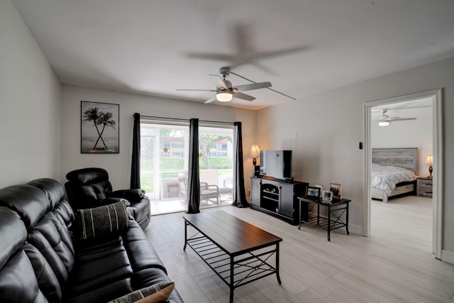 living room with light wood-type flooring and ceiling fan