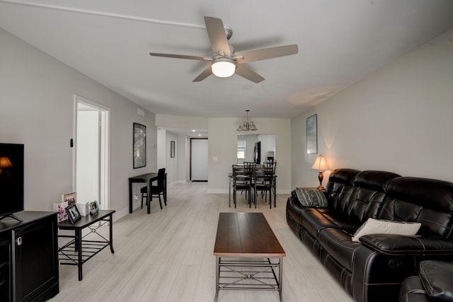 living room featuring ceiling fan and light wood-type flooring