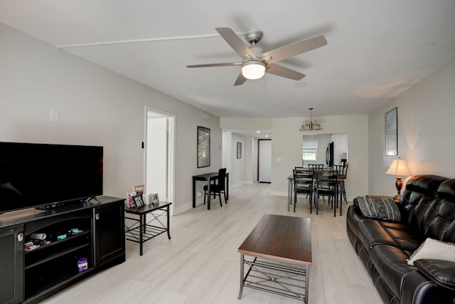 living room with ceiling fan and light hardwood / wood-style flooring