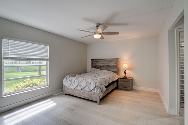 bedroom with ceiling fan and light hardwood / wood-style flooring