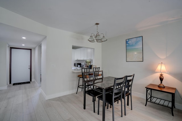 dining area with an inviting chandelier and light wood-type flooring