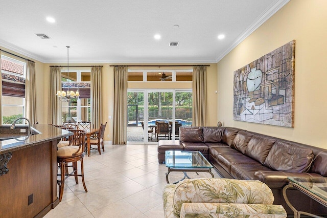 tiled living room featuring a chandelier, a textured ceiling, and ornamental molding