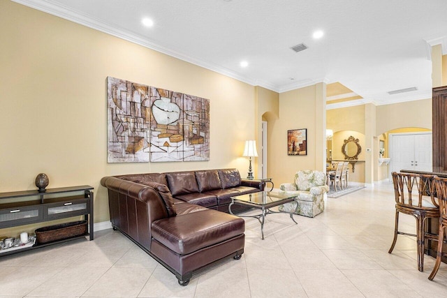 living room with light tile patterned floors and ornamental molding