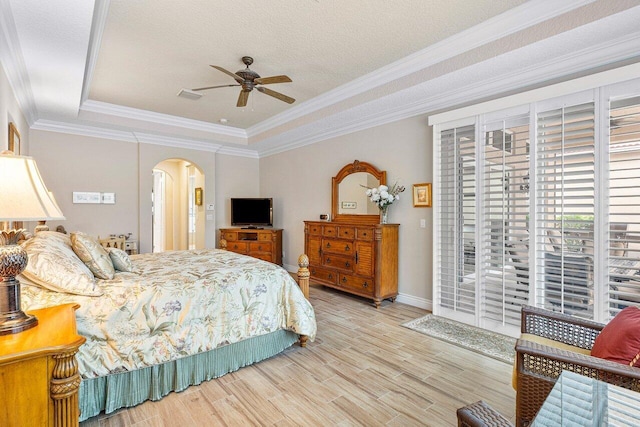 bedroom featuring ornamental molding, a tray ceiling, ceiling fan, and hardwood / wood-style flooring