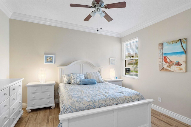 bedroom with ceiling fan, light hardwood / wood-style floors, ornamental molding, and a textured ceiling