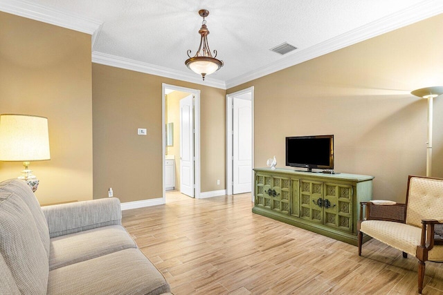 living room with wood-type flooring, a textured ceiling, and ornamental molding