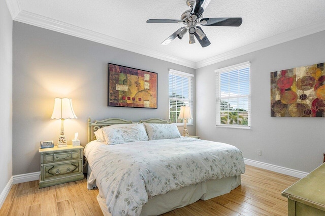 bedroom with ceiling fan, light hardwood / wood-style flooring, a textured ceiling, and ornamental molding